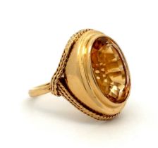 A gold and citrine dress ring with rope twist surround. Size P. Citrine approx 16 x 12mm. Engraved