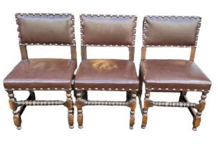 A set of six Cromwellian style oak and leather dining chairs. Each H86cm, W47cm, D43cm.