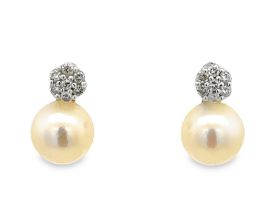 A pair of pearl and diamond 18ct white gold earrings. Posts hallmarked, backs stamped 750. Please