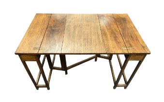 An unusual mid-Century walnut metamorphic extending table. Folded 30x52.5cm, height 57cm, extended