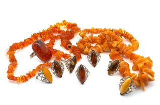 A collection of Baltic amber jewellery. A butterscotch amber necklace approximately 70cm in