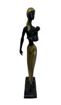 Bronze and brass tall African sculpture of a mother and child, mother walking holding her child.