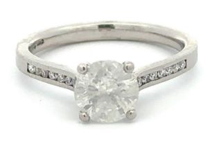 A large diamond and platinum ring with diamond shoulders and 4 claw setting. Central diamond 1.