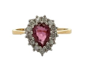 A pear cut ruby and diamond cluster ring, hallmarked 18ct. Ruby 6.5mm x 5mm. Estimated diamond