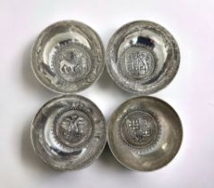 Four continental white metal bowls stamped 800. Each with a different crest inside a beaded border.