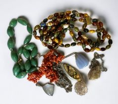 A small selection of jewellery items including a silver and moonstone pendant, a shell necklace, a