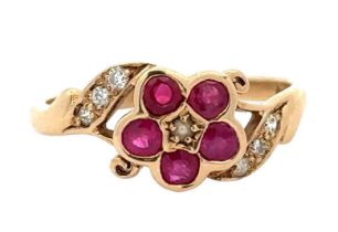 A 9ct ruby and seed pearl flower ring with diamond set shoulders. Size P. Weight 2.43g. Birmingham