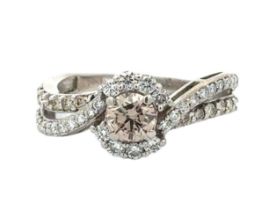 A 14ct white gold and diamond ring with twisted split shank set with diamonds. Central diamond