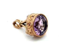 A Victorian gold and amethyst fob. The round mixed cut amethyst of approx 15mm diameter is set in