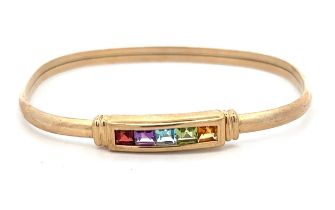A small multi gemstone hinged bangle, stamped 375, set with garnet, amethyst, topaz, peridot and