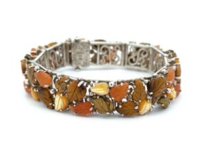 A 925 filigree bracelet by Whitney Kelly adorned with Autumn leaves carved in tiger's eye, jasper