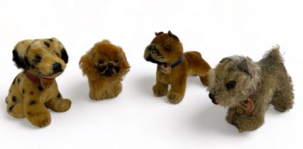 Four vintage Steiff dogs. 'Tessie' with ID tag, unjointed with grey mohair fur (13cm length). A