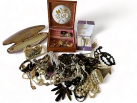 An attractive wooden jewellery box containing costume jewellery items along with a selection of