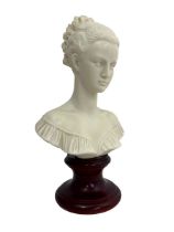 An alabaster bust of a lady on a pedestal. 35cm high.