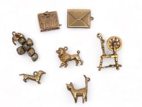 A range of seven gold charms. Six fully hallmarked, one (orb) marked '9ct and Sil'. Also includes an