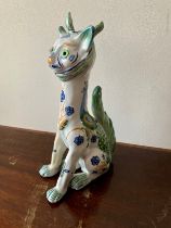Faience, Masonic seated horned French ceramic cat, white with green and blue patterns including
