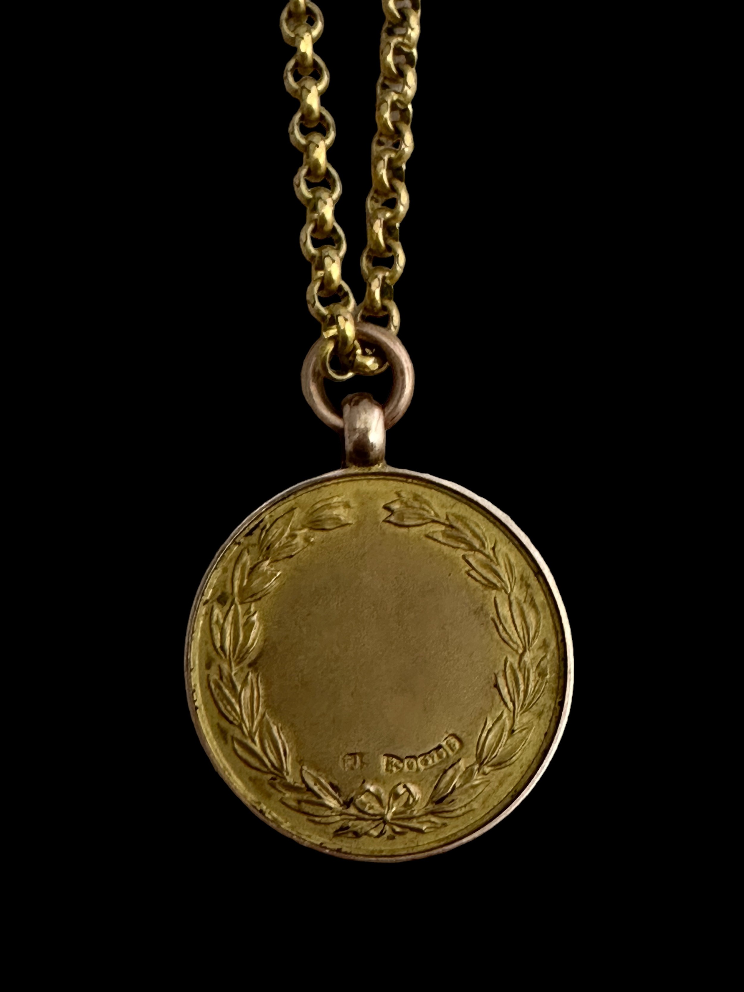 A 9ct gold medallion on a yellow metal chain. Medallion with a profile of a golfer on one side and - Image 2 of 2
