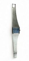 Rotary, Silver Rotary watch with rectangular blue face and integrated strap, 1975.