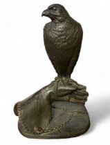 Jeanne Rynhart (Irish, 1946-2020), bronzed resin sculpture of a hawk / falcon on a falconer’s