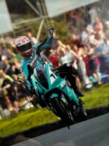 Framed signed Carl Fogarty picture. Carl Fogarty pictured on a Petronas FP1 motorbike. This was