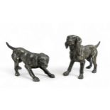 A pair of white metal dog figures of dogs, largest approx 17cm in length.