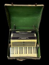 A Hohner Carmen II piano accordion in fitted case.