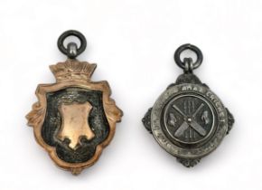 Two silver fob pendants. A silver and gilt shield design with Chester 1929 hallmarks and inscribed