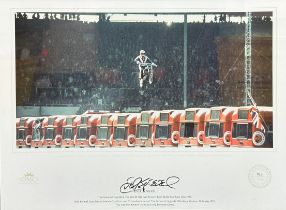 Framed signed Evil Knievel picture. The famous image of Evil Knievel jumping over 13 London buses on