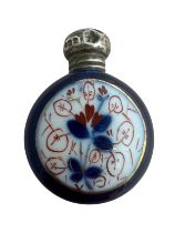 An Edwardian blue glass perfume bottle with silver mount, hand painted with floral design and with