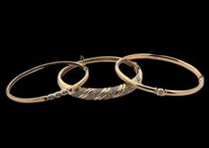 Three gold and diamond bangles. Please see the buyer's terms and conditions for purchasing