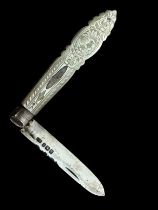 A Victorian silver fruit knife with a mother of pearl handle. Ornately decorated. Marks for Arthur