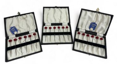 Three cased sets of six Yeoman silver plate cherry cocktail sticks