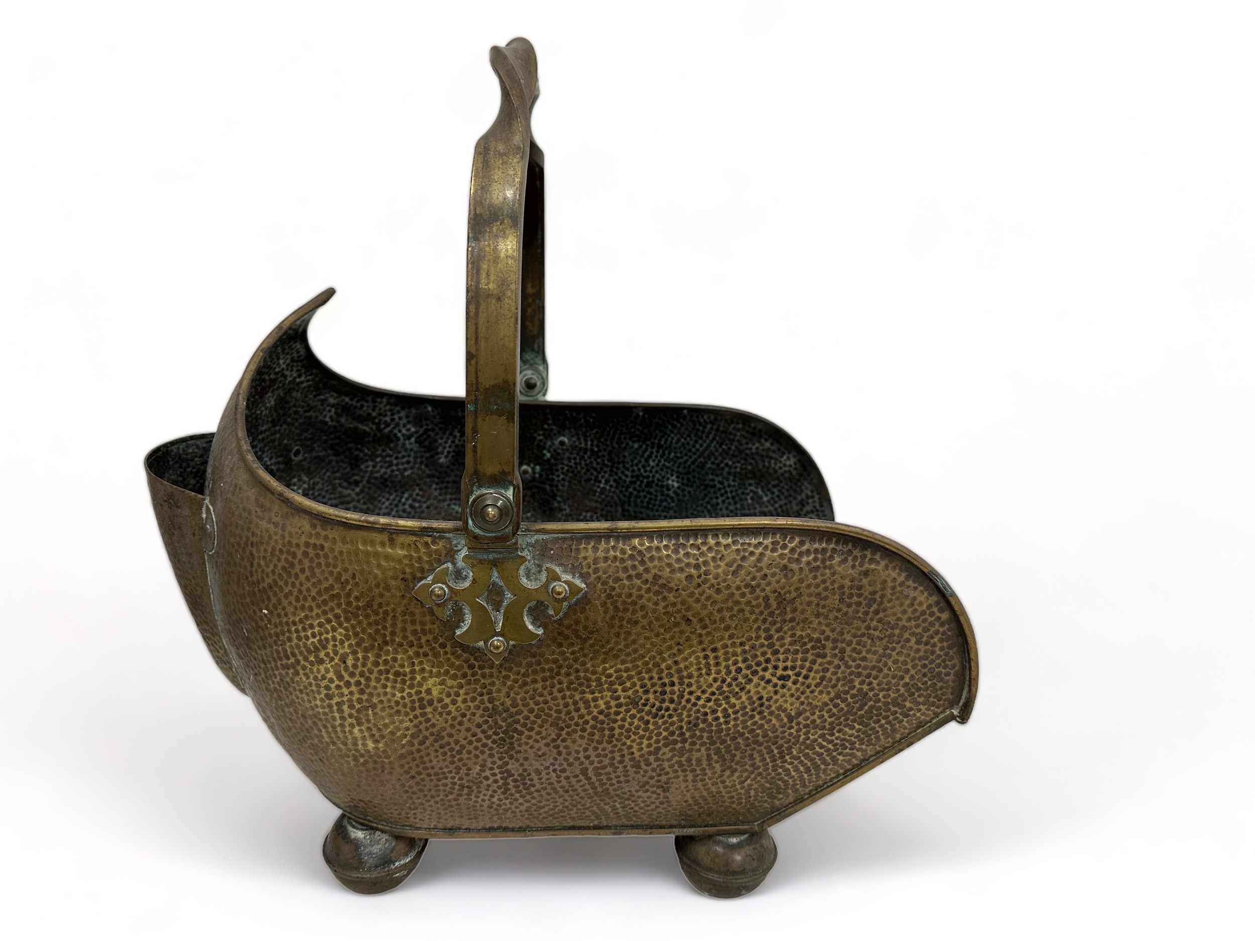 A large brass coal scuttle with twist handle and on four feet. Approx 45cm in length.