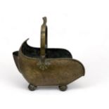 A large brass coal scuttle with twist handle and on four feet. Approx 45cm in length.