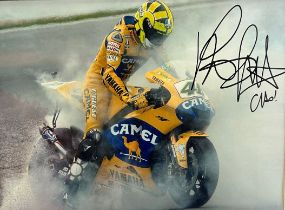 Framed signed picture of Valentino Rossi doing a burnout on his Yamaha motorbike. No COA. Frame