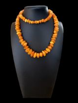 A butterscotch amber necklace, approx 24inches in length. Please see the buyer's terms and