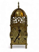 A small brass lantern clock, marked inside 'S F 8 days'. Sold as found. Height 27cm.