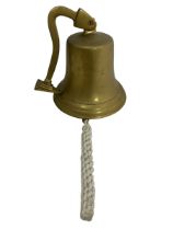 An unmarked brass ship's bell with bracket. Height 20cm.