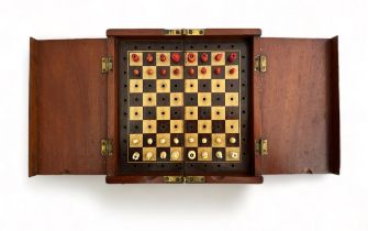 A Whittington Travel Chess Set - Complete with bone and red stained bone pieces. Circa late 19th