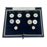 A cased octagonal white gold, mother of pearl and ruby cufflinks, button and studs set, S J Rose &