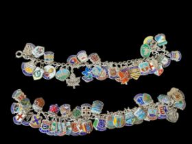 Two vintage silver charm bracelet with silver and enamel travel shields. Approx 72 charms in