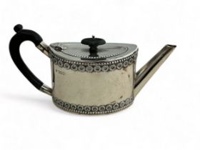 A silver bachelor's teapot of straight sided oval form, ebonised wood handle and finial. Fordham &