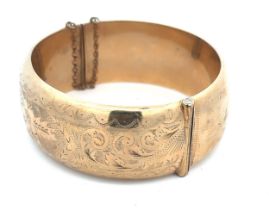 9ct gold hinged bangle with foliate design on one half and plain on the back. Hallmarks for Joseph