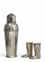 A silver plated cocktail shaker, 26cm high, and a pair of silver plated novelty boot spirit