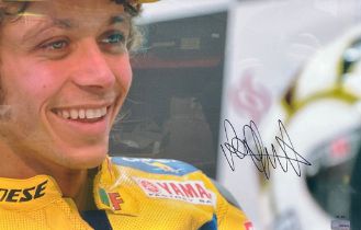 Framed signed Valentino Rossi close up picture. Large picture with plaque to bottom of frame.