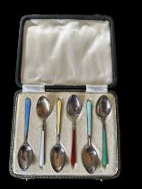 A cased set of hallmarked six silver and enamel tea spoons.