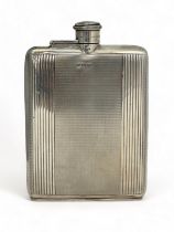 A silver hip flask with engine turned decoration by Charles S Green & Co Ltd Birmingham 1948.