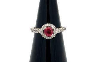 A 14ct white gold ruby and diamond cluster ring, size M/N. Ruby estimated at 0.6ct, estimated