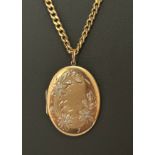 A hallmarked 9ct gold oval locket with a bi-coloured flower design. Suspended from a hallmarked