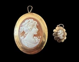 Two shell cameos depicting a lady in profile. A shell cameo brooch/ pendant, 33m in length and